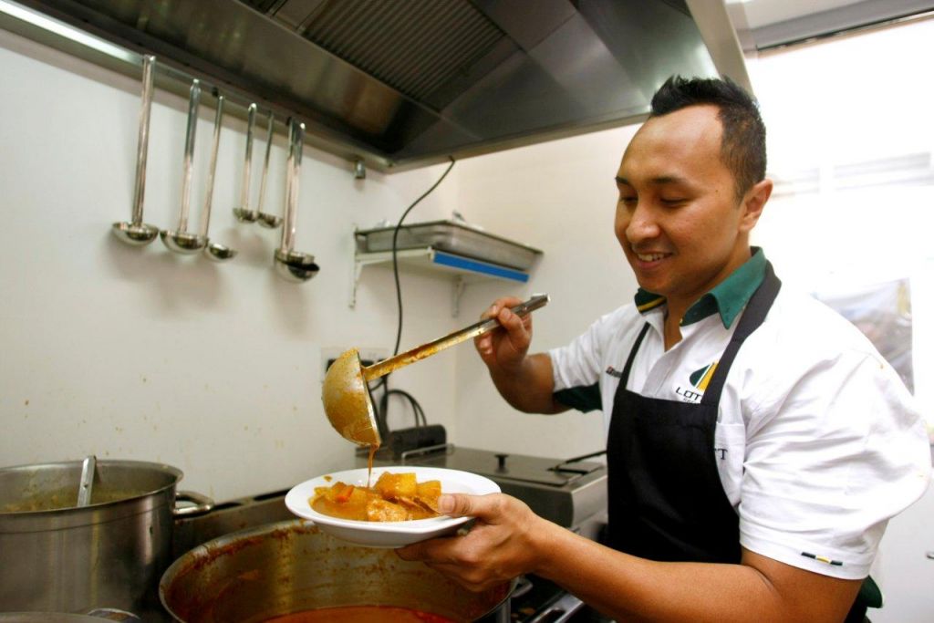 Lotus Racing's Malaysian Chef Norman Musa at Bahrain GP.jpg